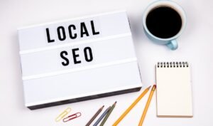 Local SEO services in Canada concept with lightbox sign, coffee, and notepad on desk